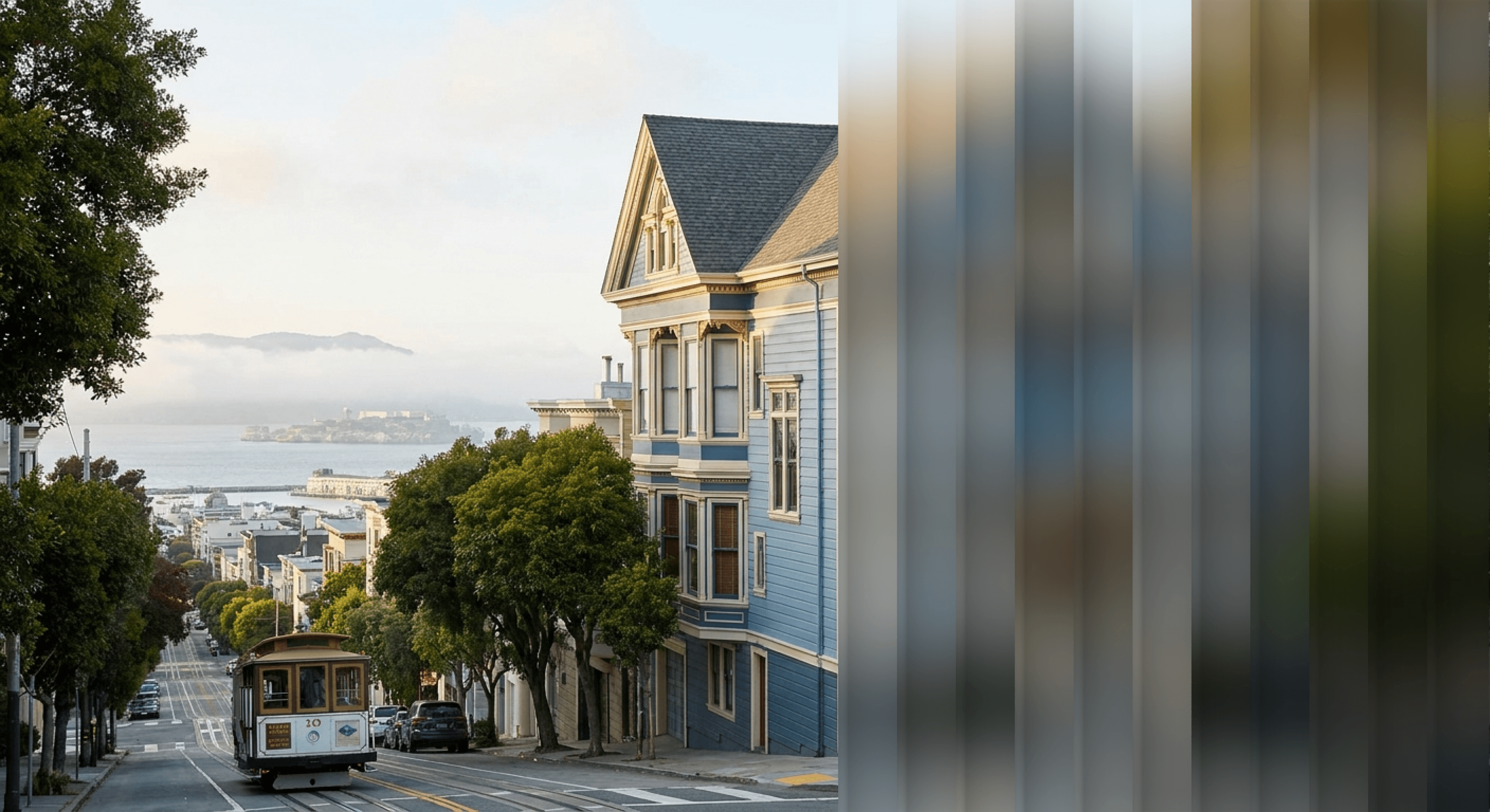 Blurred Victorian house and surrounding streetscape.